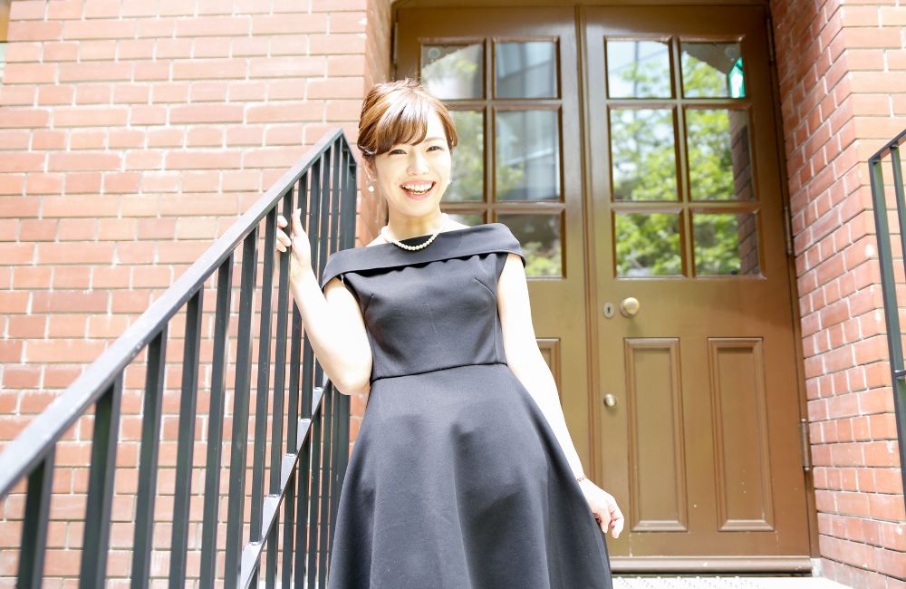 サイズがぴったり合ったレンタルドレスを着用して笑顔で立つ女性
